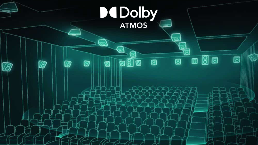 Dolby Atmos logo above a glowing teal wireframe movie theater, showing rows of seats and speakers on the walls and ceiling to illustrate immersive surround sound audio technology.
